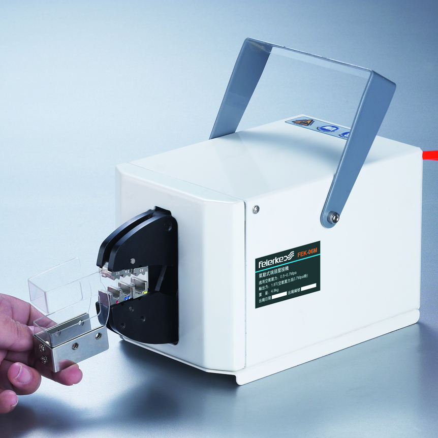 Precision pneumatic terminal crimper setup on an industrial assembly workbench